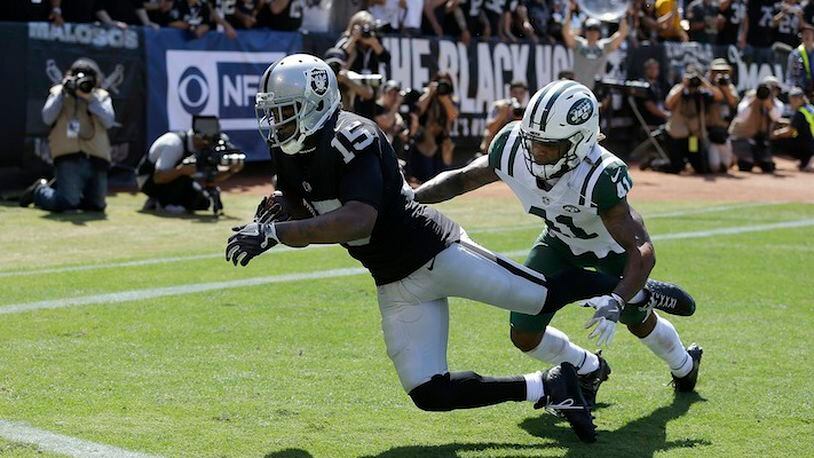 Oakland Raiders wide receiver Michael Crabtree (15) catches a touchdown pass against New York Jets defensive back Buster Skrine (41) during the first half of an NFL football game in Oakland, Calif., Sunday, Sept. 17, 2017. (AP Photo/Ben Margot)