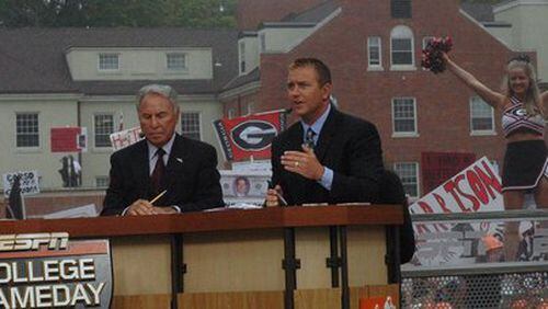 A cheerleader pops up over the left shoulder of Kirk Herbstreit during the ESPN College GameDay broadcast Sept. 27, 2008. To Herbstreit's right is Lee Corso, who picked Alabama to win the top-10 showdown later that night.