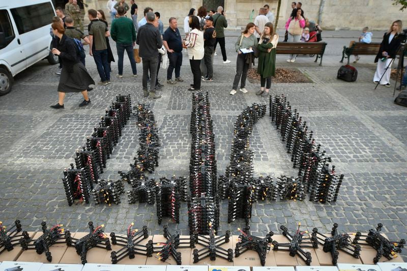 Over 800 FPV drones placed in the shape of Ukraine's state emblem, the trident, are seen in central Lviv, western Ukraine, Friday, May 10, 2024. Lviv volunteers have handed over nearly 7 300 drones to the Ukrainian army over the year in the frame of project "Birds of Victory". (AP Photo/Mykola Tys)