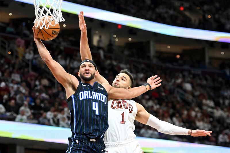 Orlando Magic's Jalen Suggs (4) shoots ahead of Cleveland Cavaliers' Max Strus (1) during the second half in Game 1 of an NBA basketball first-round playoff series, Saturday, April 20, 2024, in Cleveland. (AP Photo/Nick Cammett)