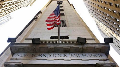 In this Friday, Nov. 13, 2015, photo, the American flag flies above the Wall Street entrance to the New York Stock Exchange, in New York. U.S. stocks are wavering between small gains and losses Thursday, Jan. 28, 2016, following a sharp sell-off the day before. (AP Photo/Richard Drew)