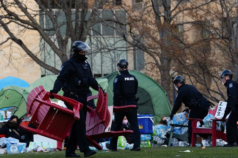 
                        Northeastern University police dismantle a barricade created with lawn chairs as they clear the encampment of pro-Palestinian protesters from the campus at Northeastern University in Boston, Mass., on Saturday, April 27, 2024. Hundreds of protesters have been arrested across the country. Police and protesters have reported being injured at some college demonstrations, but in many cases, the arrests have been peaceful, and protesters have often willingly given themselves up when officers move in. (Sophie Park/The New York Times)
                      