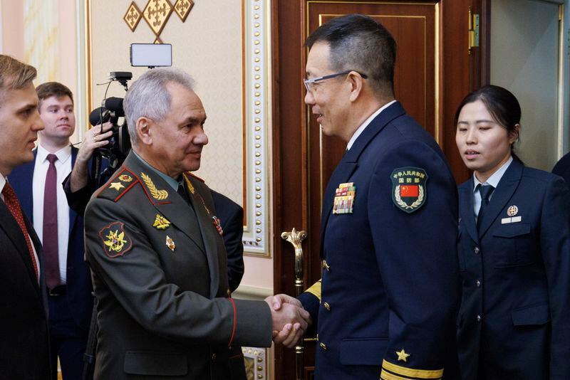 In this photo released by the Russian Defense Ministry Press Service on Friday, April 26, 2024, Russian Defense Minister Sergei Shoigu, left, shakes hands with Minister of National Defense of the People's Republic of China Dong Jun on the sidelines of the Shanghai Cooperation Organisation (SCO) Defense Ministers' Meeting in Astana, Kazakhstan. (Russian Defense Ministry Press Service via AP)
