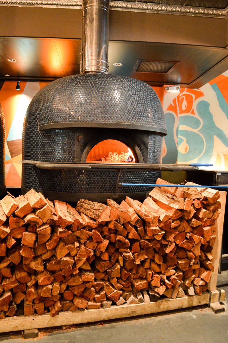 This is one of the twin wood-fired pizza ovens at Double Zero in Emory Village. CONTRIBUTED BY HENRI HOLLIS