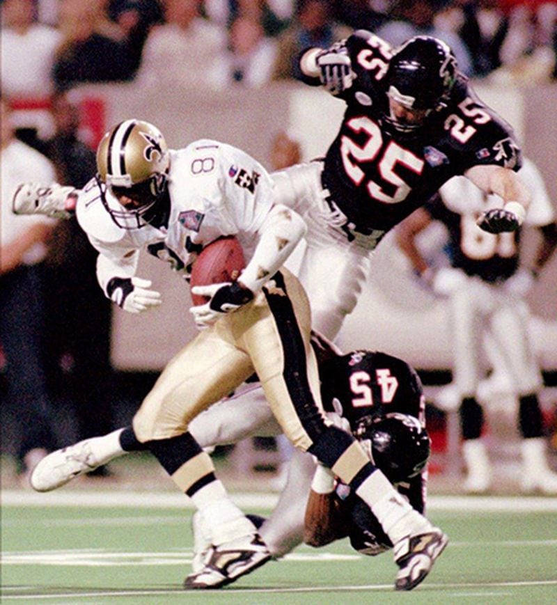 New Orleans Saints wide receiver Michael Haynes pulls in a Jim Everett pass over Falcons Scott Case (25) and Darrell Walker during in 1994. (AP)