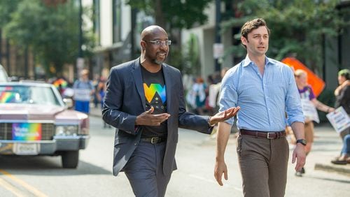 U.S. Sens. Raphael Warnock, left, and Jon Ossoff, shown participating in October in Atlanta's Pride Parade, voted in favor of advancing a bill to create a federal law protecting the rights of consenting adults to wed. (Jenni Girtman for The Atlanta Journal-Constitution)