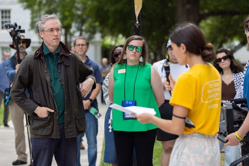 Emory junior Soju Hokari (right) reads a list of demands to representatives from the office of the president, Matt Kivel (left) and Kristen Crawford (center), at Emory University in Atlanta on Monday, April 29, 2024, including the resignation of President Gregory L. Fenves. Police arrested pro-Palestine protesters on campus the previous week. (Arvin Temkar / AJC)