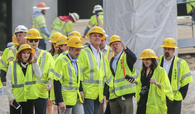 April 12, 2017 Atlanta: U.S. Senator David Perdue (R-GA) (center) observes as he was given a tour of the I-85 construction site with the Georgia Department of Transportation Commissioner Russell McMurry (center-right pointing) on Wednesday, April 12, 2017. The contractor rebuilding the I-85 bridge in Atlanta could earn up to $3.1 million extra for finishing the project early. Georgia Department of Transportation Commissioner Russell McMurry Wednesday announced contractor C.W. Matthews can earn an extra $1.5 million for completing the project by May 25 three weeks earlier than the target June 15 completion date. The contractor could earn $2 million for completing it by May 21 and $200,000 for each day before that, up to a total of $3.1 million. McMurry toured the site of the bridge collapse Wednesday with Sen. David Perdue. The commissioner said the total cost of rebuilding the bridge remains ÛÏdynamic,Û? and offered no price tag. But the federal government is expected to pay most of the cost. JOHN SPINK /JSPINK@AJC.COM