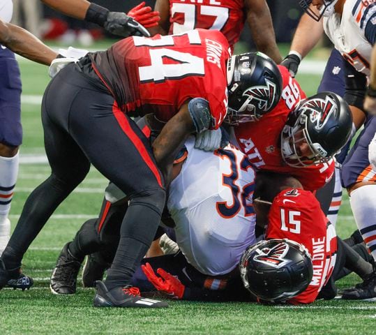 Atlanta's Rashaan Evans (54), Abdullah Anderson (98) and DeAngelo Malone stop Bears running back David Montgomery during the third quarter Sunday at Mercedes-Benz Stadium. (Bob Andres / for The Atlanta Journal-Constitution)