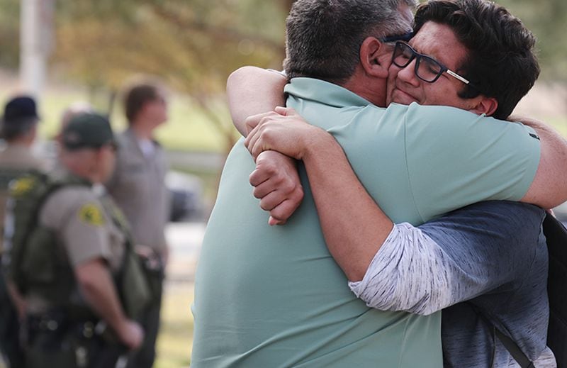 Kurt Rennels hugs  son Eric after reuniting at a park near Saugus High School after the shooting.