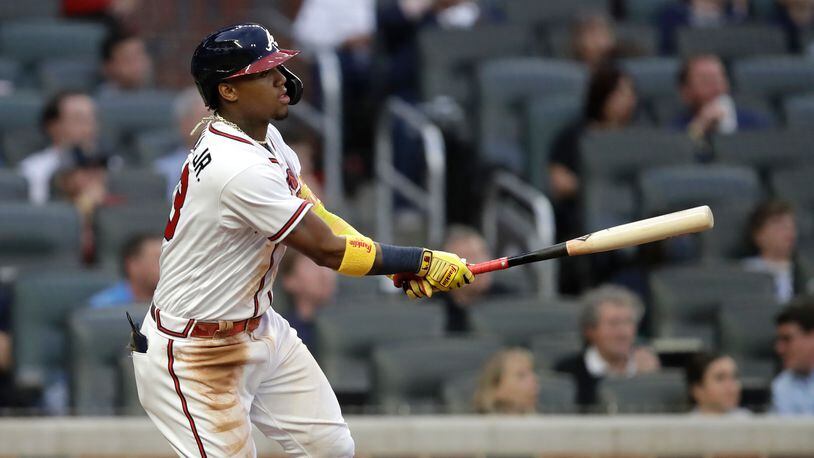 Atlanta Braves' Ronald Acuna Jr. swings for a home run off Toronto Blue Jays pitcher Robbie Ray in the third inning of a baseball game Tuesday, May 11, 2021, in Atlanta. (AP Photo/Ben Margot)