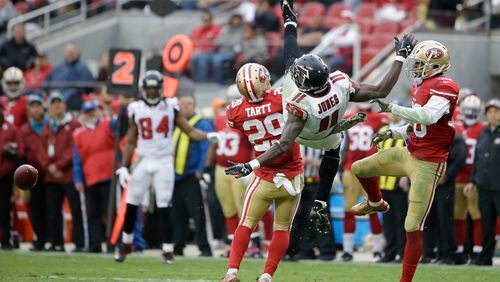 Atlanta Falcons wide receiver Julio Jones (11) cannot catch a pass while defended by San Francisco 49ers strong safety Jaquiski Tartt (29) and defensive back Dontae Johnson during the second half of an NFL football game in Santa Clara, Calif., Sunday, Nov. 8, 2015. (AP Photo/Marcio Jose Sanchez)