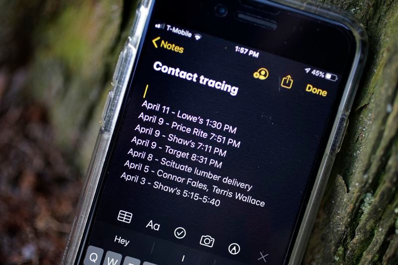A smartphone belonging to Drew Grande, 40, of Cranston, R.I., shows notes he made for contact tracing Wednesday, April 15, 2020. Grande began keeping a log on his phone at the beginning of April, after he heard Rhode Island Gov. Gina Raimondo urge residents to start out of concern about the spread of the coronavirus. (AP Photo/Steven Senne)