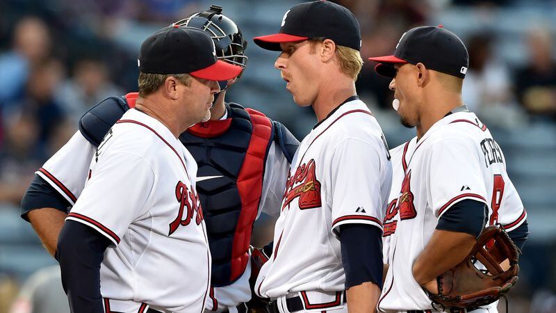 Mike Foltynewiez (center) in his Braves debut and first major league appearance as a starter in 2015, gets a visit from then pitching coach Roger McDowell in the first inning.