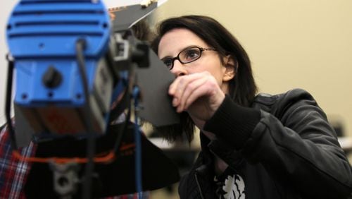 Laura Hofer, 31, inspects a piece of lighting equipment during the on-set film production class at Gwinnett Technical College. The class is part of the Georgia Film Academy Certificate Program that will prepare students for on-set jobs in the film industry. TAYLOR CARPENTER / TAYLOR.CARPENTER@AJC.COM