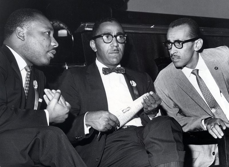 In a Sept. 25, 1963 photo, The Rev. Martin Luther King, Jr., left, vice president Joseph E. Lowery, and Wyatt Tee Walker, right, executive director of the SCLC meet at First African Baptist Church, for the SCLC convention in Richmond, Virginia. Archive.