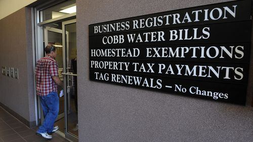 A customer enters the Cobb County Government Service Center in Austell. File photo.