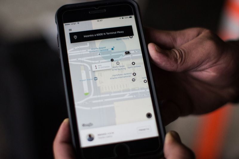 Naas Nassreddin, who arrived from Italy, shows his Uber app that displays where his driver is located as he waits at the designated rideshare area at Hartsfield-Jackson Atlanta International Airport , Monday, Jan. 2, 2017, in Atlanta. BRANDEN CAMP/SPECIAL