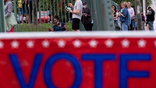 Voters wait in line at the Fanplex voting site late Tuesday evening June 9, 2020 across from the old Turner Field in Atlanta. Voters were reporting a three-hour wait at the site. Ben Gray for the Atlanta Journal-Constitution