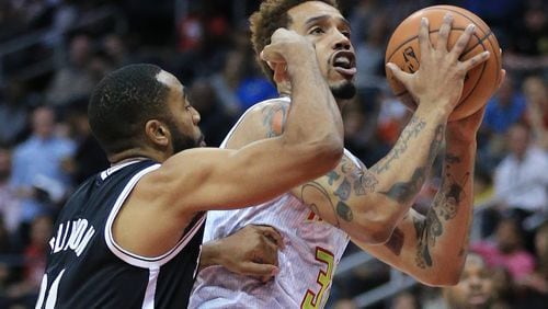 Hawks’ Mike Scott is fouled by Nets Wayne Ellington on his way to the basket during the first period in a basketball game on Wednesday, Nov. 4, 2015 in Atlanta. Curtis Compton / ccompton@ajc.com