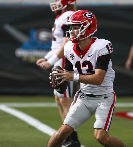 10/30/21 - Jacksonville -  Georgia Bulldogs quarterback Stetson Bennett (13) warms up before the game at the annual NCCA  Georgia vs Florida game at TIAA Bank Field in Jacksonville.   Bob Andres / bandres@ajc.com