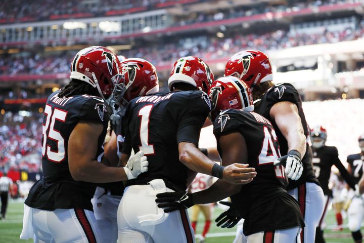 Falcons teammates celebrate with quarterback Marcus Mariota (1) after he scored a touchdown against the 49ers on Sunday in Atlanta. (Miguel Martinez / miguel.martinezjimenez@ajc.com)