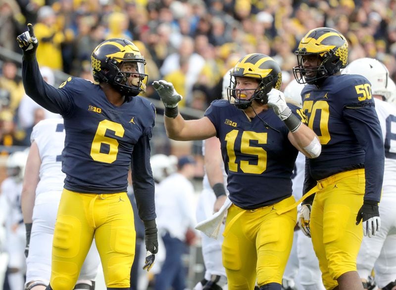Michigan's Chase Winovich, center, celebrates his sack against Penn State with teammates.