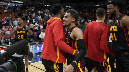 Hawks guard Trae Young, center left, and forward Saddiq Bey (41) celebrate with teammates after the Hawks defeated the Miami Heat in an NBA basketball play-in tournament game Tuesday, April 11, 2023, in Miami. (AP Photo/Rebecca Blackwell)