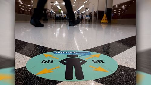 Floor markers at Hartsfield-Jackson Airport encourage social distancing Friday, May 15, 2020.