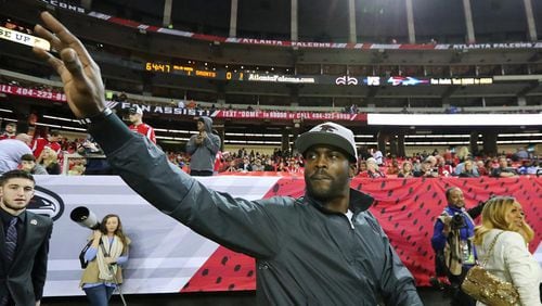 Former Falcons quarterback Michael Vick waves to fans as he returns to the Georgia Dome for ceremony paying tribute to the retiring stadium before the team plays the final regular season game against the New Orelands Saints on Sunday, Jan. 1, 2017, in Atlanta. (Curtis Compton/ccompton@ajc.com)