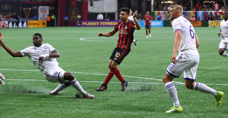 Atlanta United midfielder Pity Martinez scores his first goal of the season past Orlando City defenders  Sunday, May 12, 2019, in Atlanta.