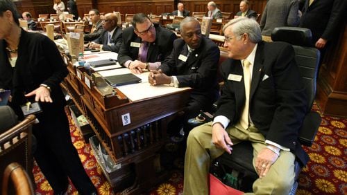 State Rep. Rusty Kidd, right, talks with Reps. Billy Mitchell, D-Stone Mountain, center, and Pedro “Pete” Marin, D-Duluth, during the 2012 legislative session. Kidd, an independent from Milledgeville, died Tuesday. Jason Getz jgetz@ajc.com