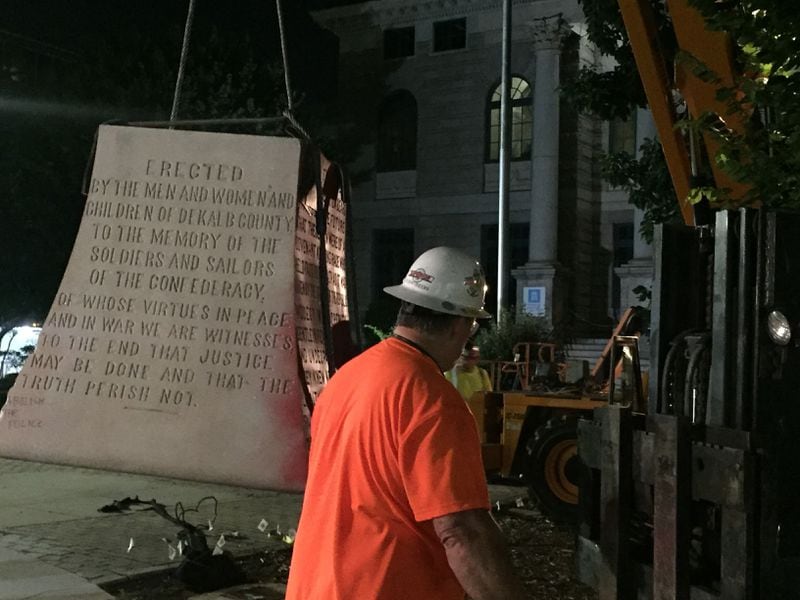 The pedestal of Decatur’s Confederate monument, which bears the engravings honoring DeKalb’s Confederate soldiers, is removed from Decatur Square late Thursday, June 18, 2020
