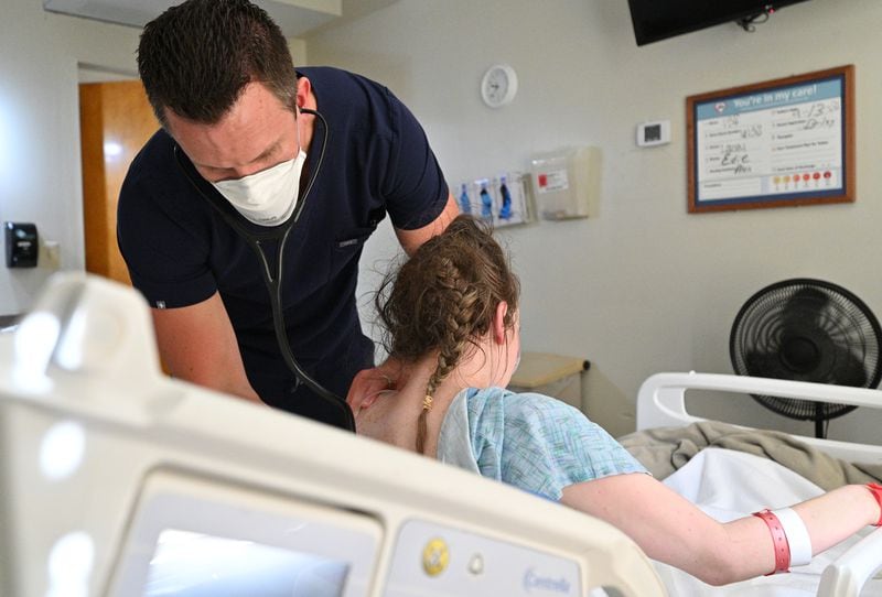 Dr. Jason Laney checks a patient recovering from COVID-19 at Jeff Davis Hospital in Hazlehurst on Monday. He and the hospital staff celebrate recoveries, after losing 38 patients to the coronavirus infection. (Hyosub Shin / Hyosub.Shin@ajc.com)