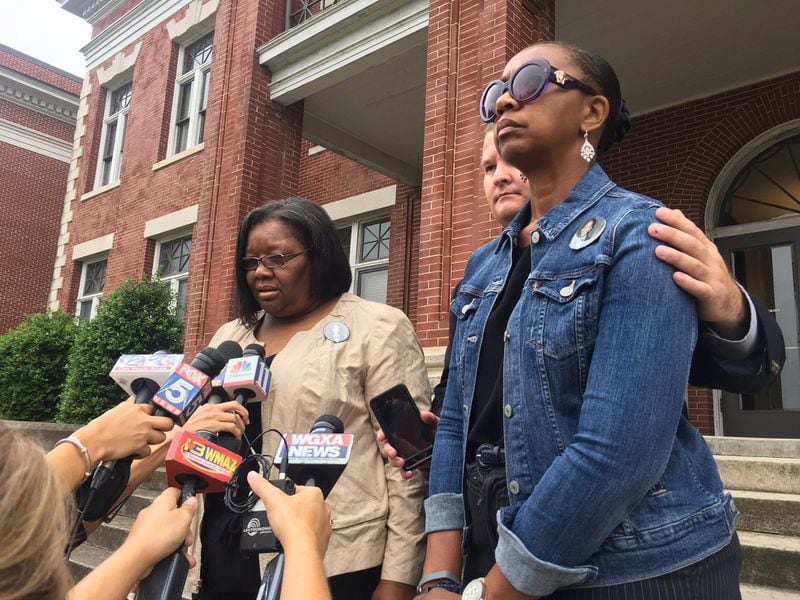 Carol Billeue (left) and Denise Billeue, speak to the media after a court hearing at the Putnam County courthouse in Eatonton on Wednesday, June 21, 2017. Two inmates, Ricky Dubose and Donnie Russsell Rowe, are accused of killing Billue and another correctional officer while escaping from a prison transport bus. A state prosecutor said Wednesday that he will seek the death penalty against them. The pair was denied bond. (RHONDA COOK/AJC)