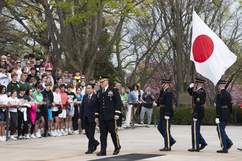 Japan's Prime Minister Fumio Kishida, is accompanied by Commanding General Military District of Washington Maj. Gen. Trevor Bredenkamp, right, during a wreath laying ceremony at the Tomb of the Unknown Soldier, at Arlington National Cemetery, in Arlington, Va., Tuesday, April 9, 2024. (AP Photo/Manuel Balce Ceneta)