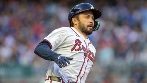 Atlanta Braves catcher Travis d'Arnaud (16) runs after doubling on a line drive during the second inning at Truist Park on Wednesday, May 15, 2024. (Arvin Temkar / AJC)