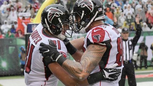 Atlanta Falcons tight end Austin Hooper (81) celebrates after scoring a touchdown with Levine Toilolo (80) during the first half of an NFL football game against the New York Jets Sunday, Oct. 29, 2017, in East Rutherford, N.J. (AP Photo/Bill Kostroun)