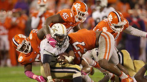 Teammates Jabril Robinson (50) and Tre Lamar (57) of the Clemson Tigers stop KirVonte Benson (30) of the Georgia Tech Yellow Jackets during their game at Memorial Stadium on October 28, 2017 in Clemson, South Carolina.  (Photo by Streeter Lecka/Getty Images)