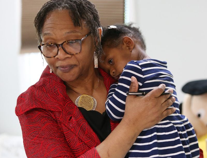 Wanda Irving holds Soleil Irving, 2, in their home in Sandy Springs.