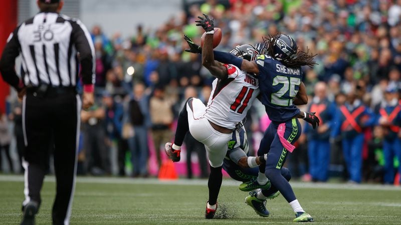 Wide receiver Julio Jones can't make the catch on fourth down as cornerback Richard Sherman defends Oct. 16, 2016, at CenturyLink Field in Seattle.