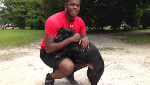 Georgia Tech incoming freshman punter Pressley Harvin III with his shorthaired Labrador Rocky at Harvin’s home in South Carolina on May 31, 2017. (AJC photo by Ken Sugiura)