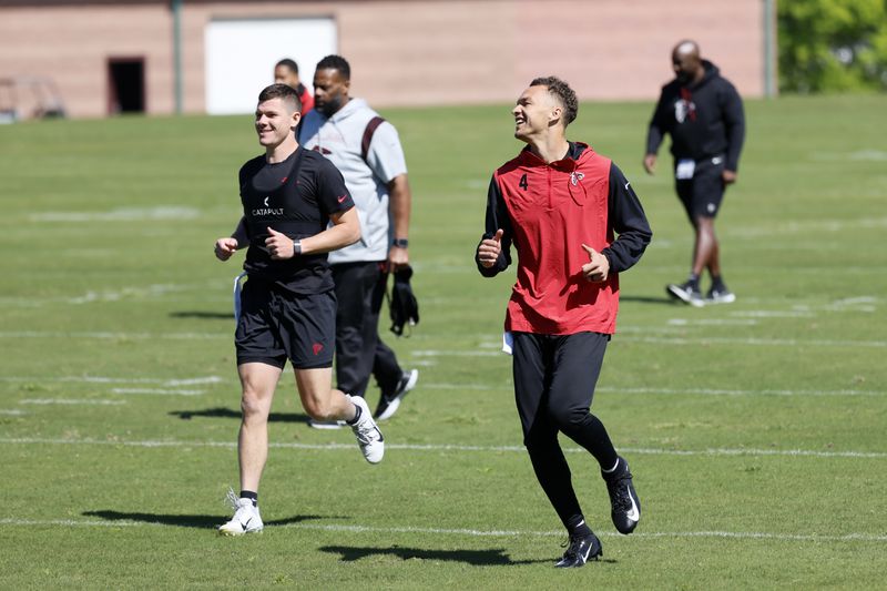 Falcons quarterback Desmond Ridder (4) smiles with teammates as he participates in an offseason conditioning program at the Atlanta Falcons Practice Facility Tuesday, April 18, 2023, in Flowery Branch, Ga.
Miguel Martinez /miguel.martinezjimenez@ajc.com

