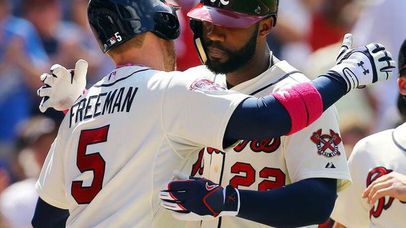 Jason Heyward gets a hug from Freddie Freeman after Heyward's two-run homer in Sunday's win against the Cubs, which ended a homerless drought of more than 100 at-bats for Heyward.