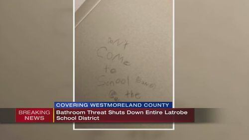 A threat written on a bathroom in a Latrobe, Pennsylvania school has led to the cancellation of classes on Friday.