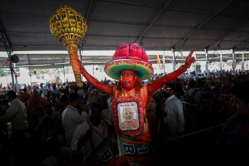 A supporter of India's ruling Bharatiya Janata Party holds a mace, used as a weapon by Hindu god Hanuman, as he shouts slogans during an election campaign rally addressed by Indian Prime Minister Narendra Modi in the northern Indian city of Meerut, March 31, 2024. (AP Photo/Altaf Qadri)