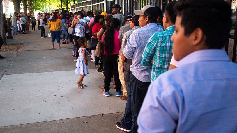 Long lines form outside the Atlanta Immigration Court in 2019. STEVE SCHAEFER / SPECIAL TO THE AJC