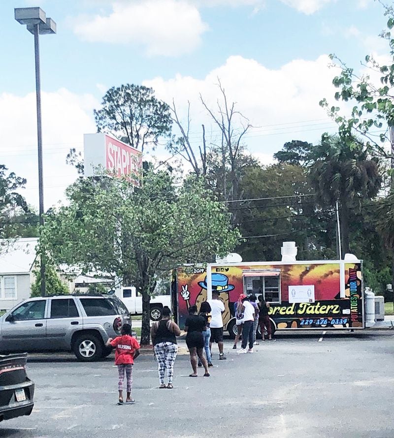 Albany residents can be seen standing in line for a food truck Tuesday in this photo provided to the AJC. Two days earlier, Mayor Bo Dorough had asked residents to practice social distancing and cited food truck lines as a potential health risk. SPECIAL