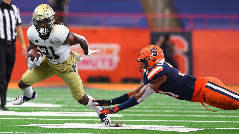 Georgia Tech Yellow Jackets running back Jahmyr Gibbs (21) runs with the ball past the diving tackle attempt of Syracuse Orange linebacker Geoff Cantin-Arku (31) during the first quarter at the Carrier Dome. (Rich Barnes-USA Today Sports)