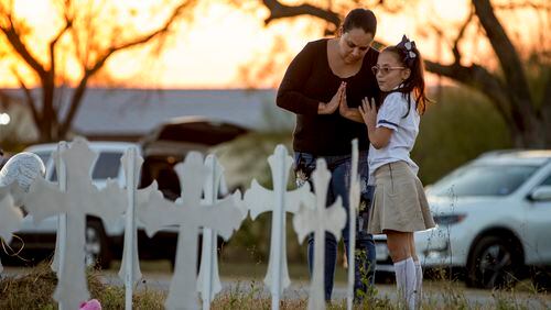 USE THIS LEDE INSIDEMeredith Cooper, of San Antonio, and her eight-year-old daughter, Heather, visit a memorial of 26 metal crosses near First Baptist Church in Sutherland Springs on Monday November 6, 2017.  JAY JANNER / AMERICAN-STATESMAN